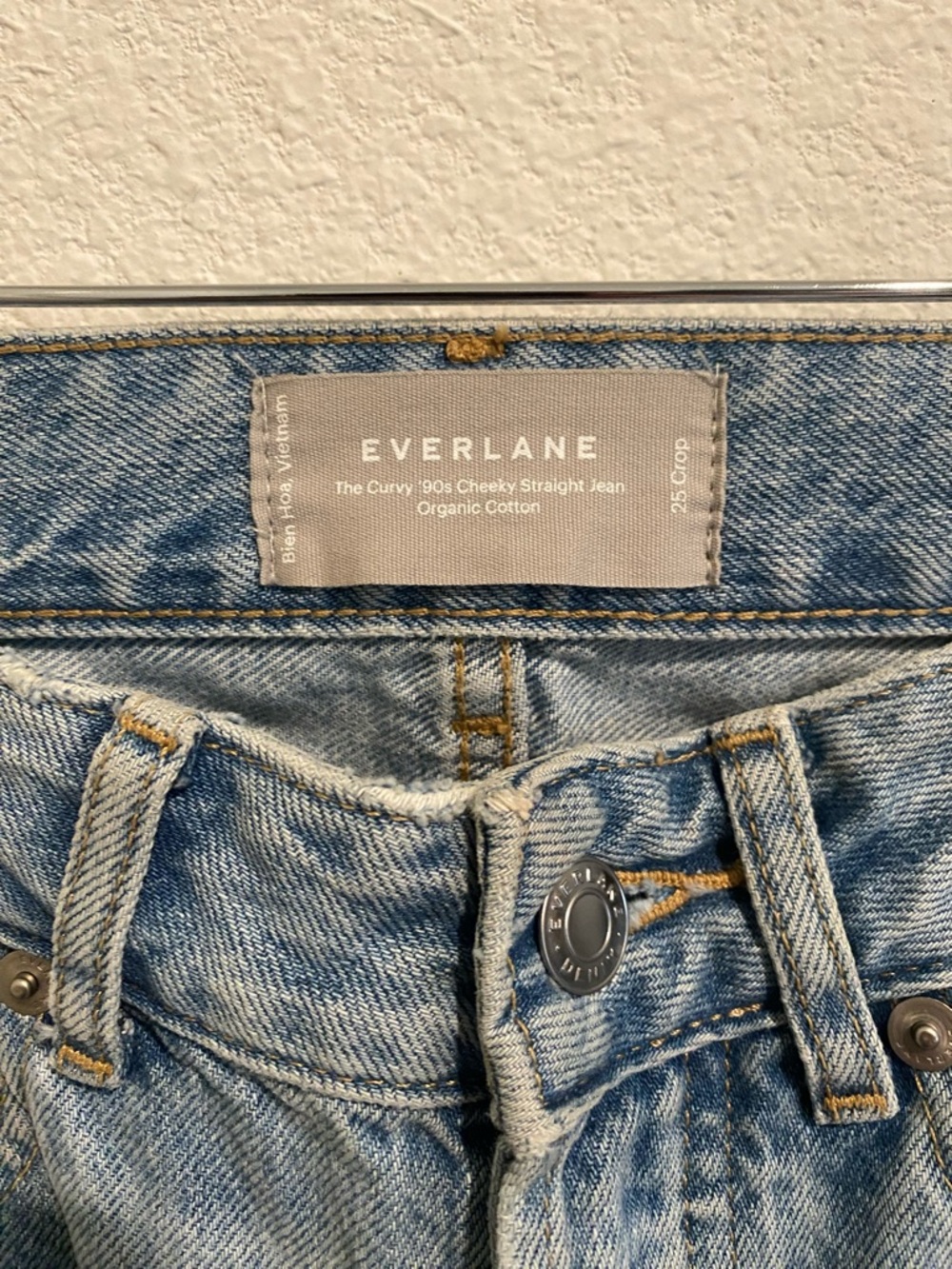 Everlane light blue denim jeans with tan leather patch